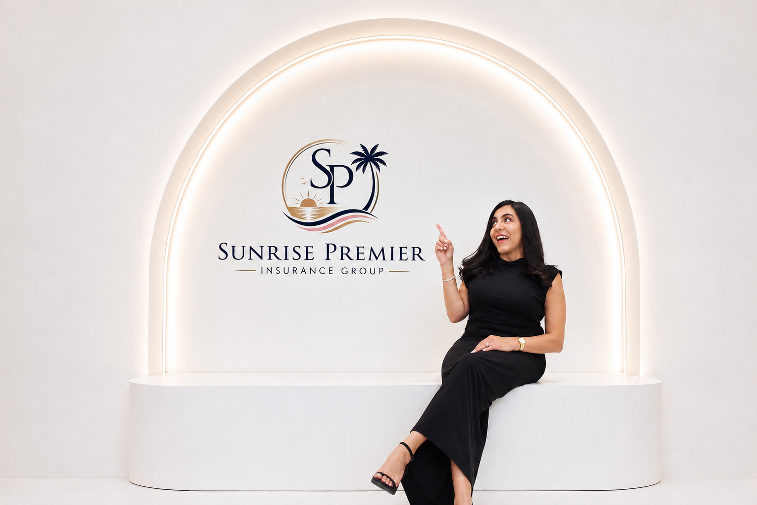Founder of Sunrise Premier Insurance Group seated beside the company logo